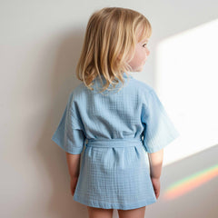 girl wearing a light blue cotton robe