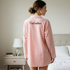 Back view of pink gingham nightshirt with elegant Valentine script embroidery in dark red