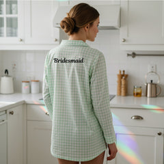 Back view of a bridesmaid wearing a green checkered sleepshirt with Bridesmaid text embroidery