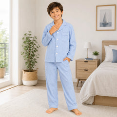Child wearing blue pajamas in a bedroom