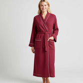 maroon waffle-texture long robe with white piping and pockets.