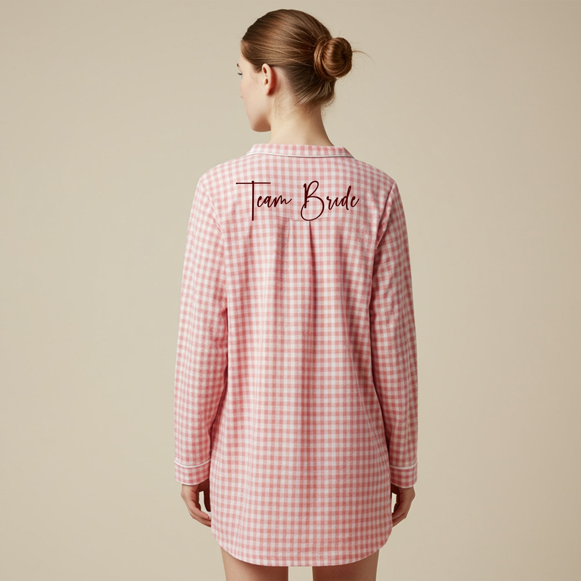 Back view of a pink checkered sleepshirt featuring purple Bridesmaid embroidery