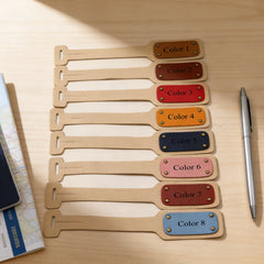 Set of eight wooden name tags with color labels on a wooden surface.