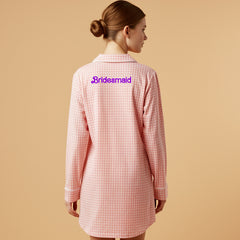 Woman in pink gingham nightshirt with bold red Valentine embroidery on the back