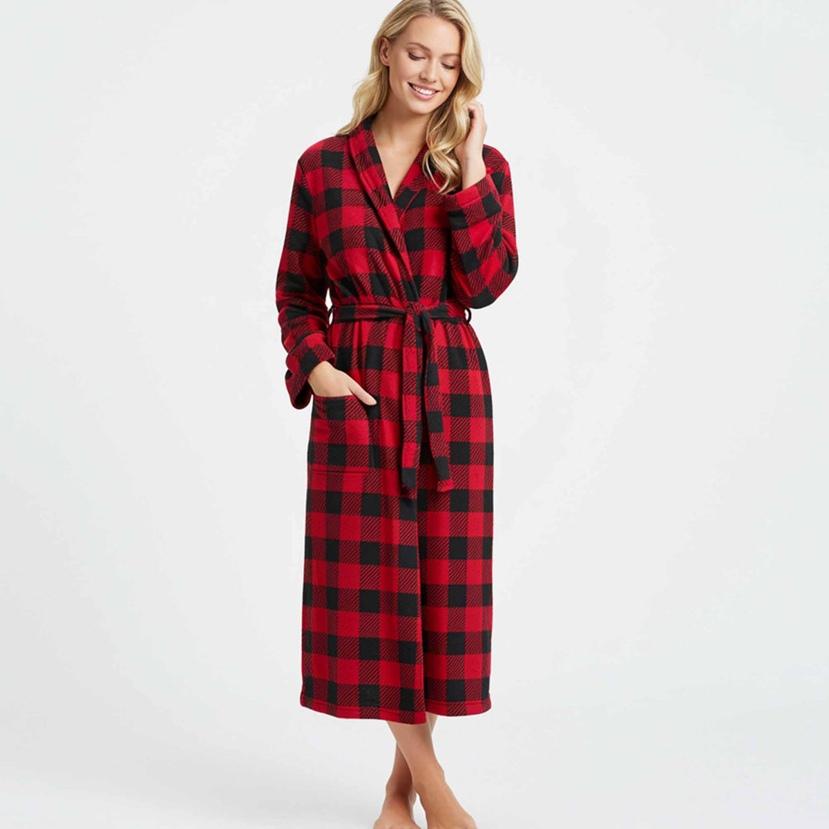 wearing a long red and black buffalo plaid fleece robe with pockets and a waist tie