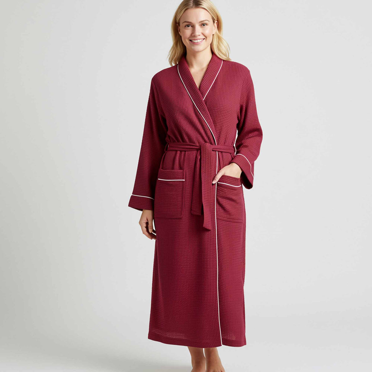 maroon waffle-texture long robe with white piping and pockets.