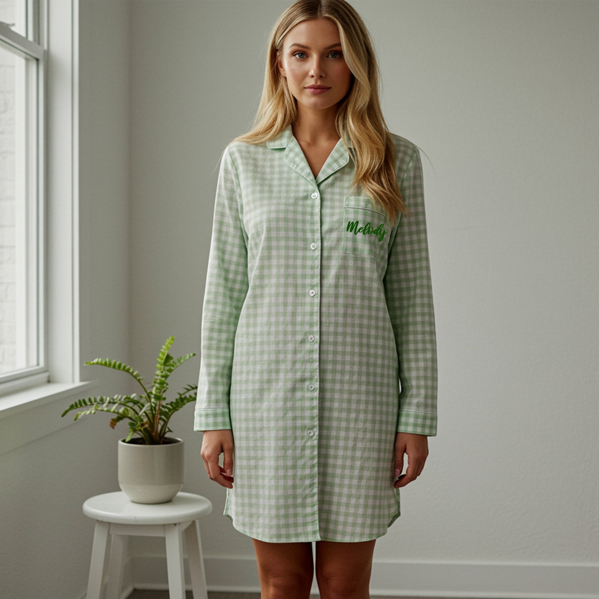 Woman wearing a personalized sage green gingham sleepshirt with green embroidery on the pocket