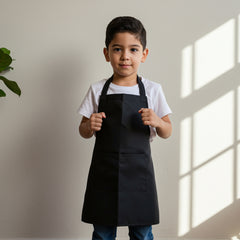 young boy modeling black kids apron for creative activities
